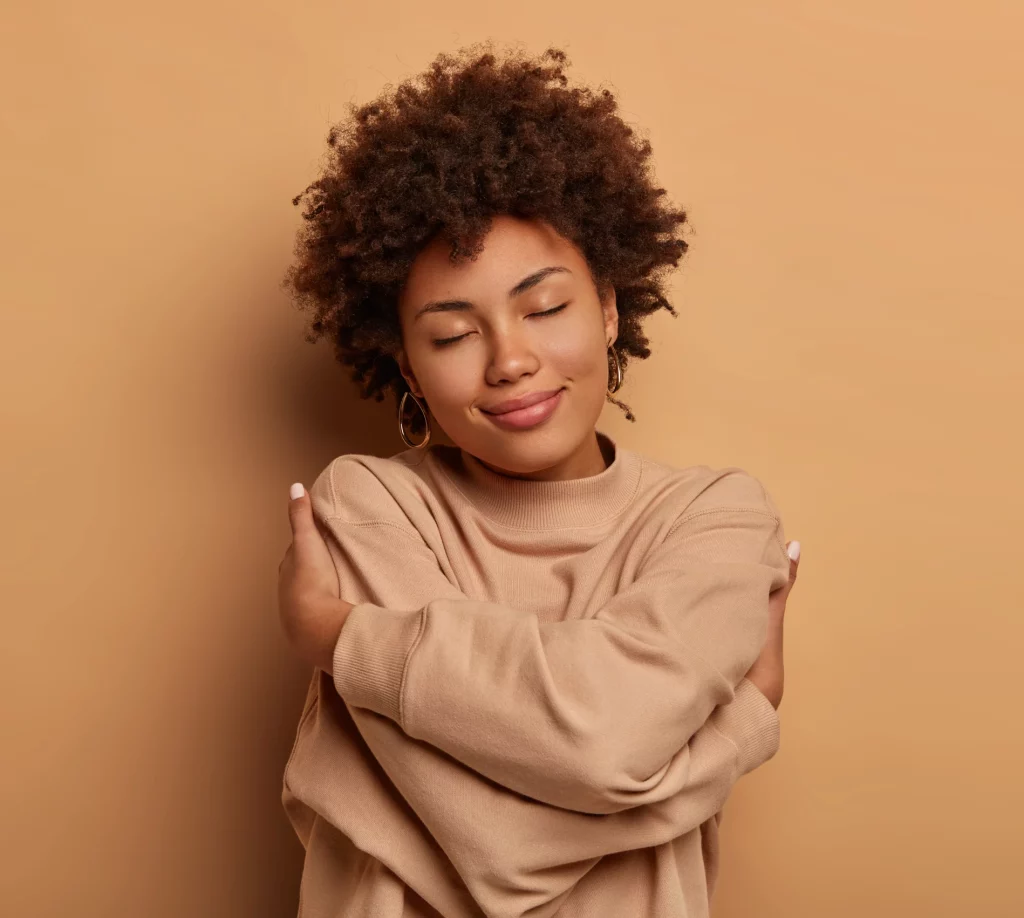 femme, les bras croisés contre son buste